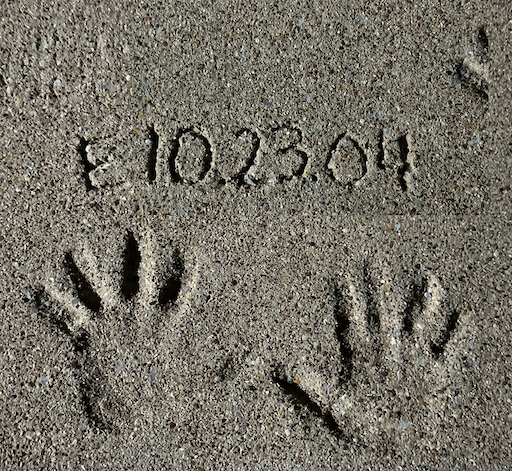 childhood hands dated in concrete