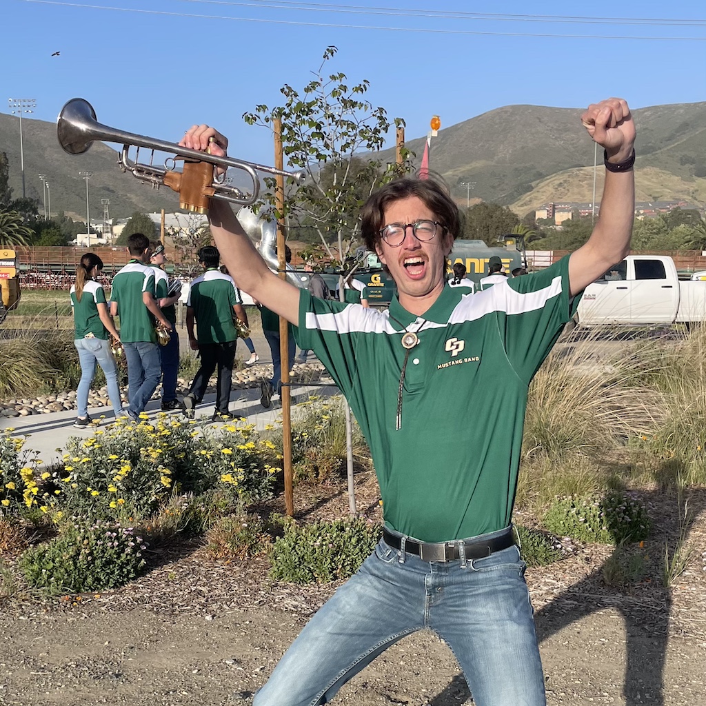 a celebratory pose with a trumpet at the rodeo